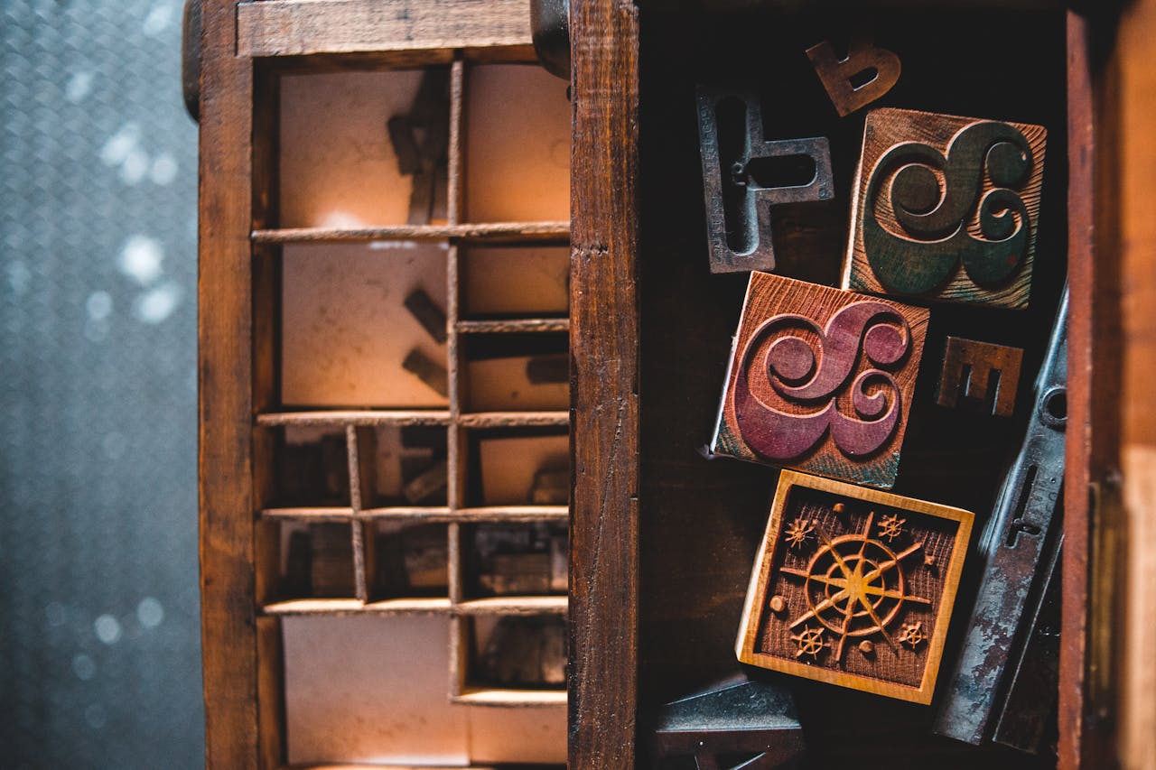 A collection of vintage wooden letterpress blocks in a workshop setting, embodying nostalgia and creativity.
